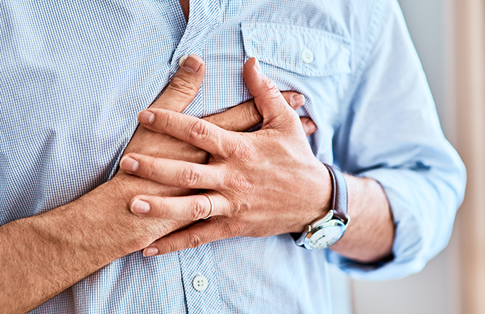 Picture of a man with chest pain; chest pain is one of the lung cancer warning signs