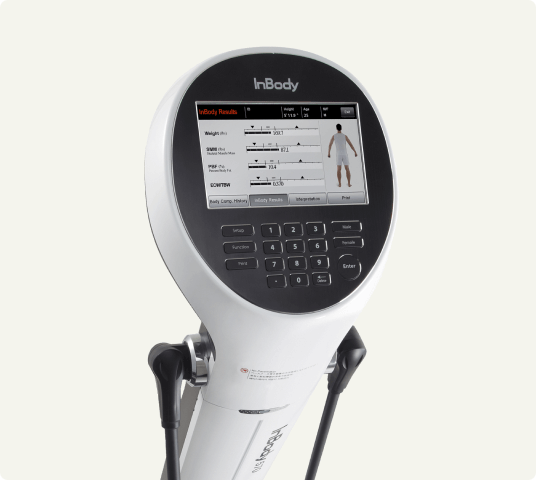 Close-up of an InBody body composition analyzer displaying weight, muscle mass, and fat analysis on its screen, used for precise health and fitness measurements.