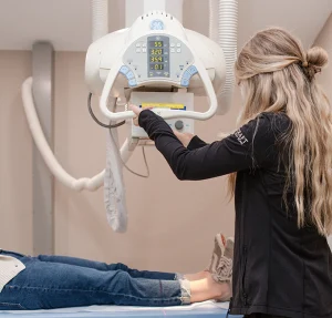 Radiology technician assisting with scan procedure